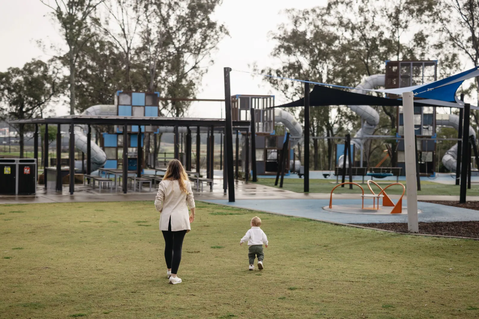 Huntlee resident and child walking through a park